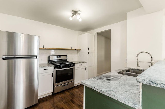 786 Ann St, Columbus, OH 43206 - kitchen with stainless steel appliances, dark wood-style flooring, backsplash, and light stone counters