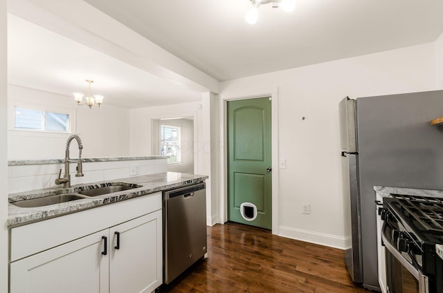 786 Ann St, Columbus, OH 43206 - kitchen with dishwasher, black gas range, light stone counters, white cabinets, and a chandelier