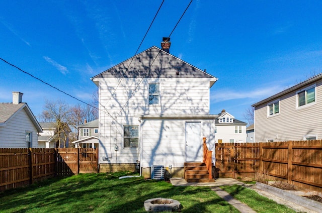 786 Ann St, Columbus, OH 43206 - rear view of property with a fenced backyard, a chimney, entry steps, and a fire pit