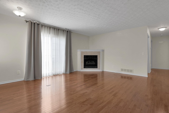 4686 Parrau Dr Unit 64A, Columbus, OH 43228 - unfurnished living room with wood finished floors, a fireplace, and a textured ceiling
