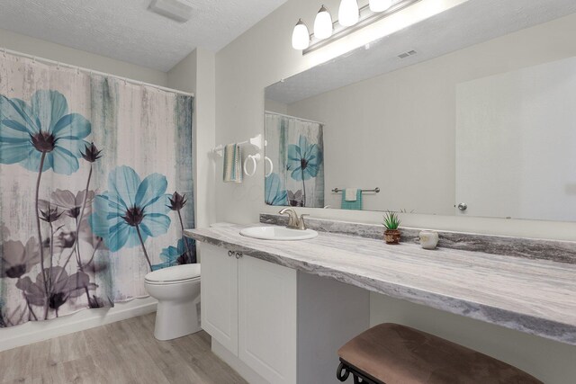 4686 Parrau Dr Unit 64A, Columbus, OH 43228 - bathroom featuring wood finished floors, vanity, and a textured ceiling