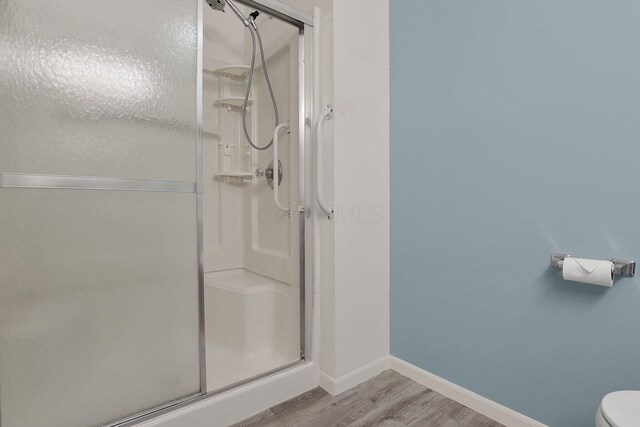 4686 Parrau Dr Unit 64A, Columbus, OH 43228 - full bathroom featuring wood finished floors and a stall shower