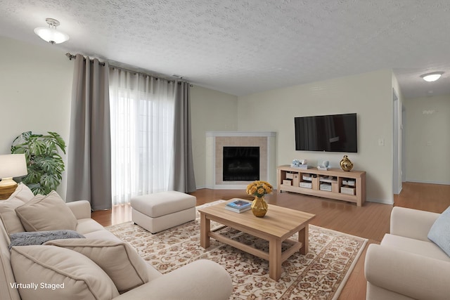 4686 Parrau Dr Unit 64A, Columbus, OH 43228 - living area featuring a textured ceiling, wood finished floors, and a fireplace