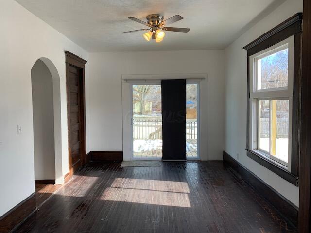 86 Curtis Ave, Newark, OH 43055 - empty room with arched walkways, healthy amount of natural light, hardwood / wood-style flooring, and a ceiling fan