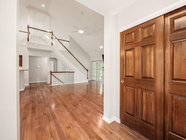 6003 Dunabbey Loop, Dublin, OH 43017 - entryway with wood finished floors, a ceiling fan, stairs, and high vaulted ceiling