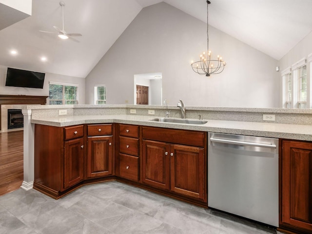 6003 Dunabbey Loop, Dublin, OH 43017 - kitchen with stainless steel dishwasher, a ceiling fan, a chandelier, open floor plan, and a fireplace