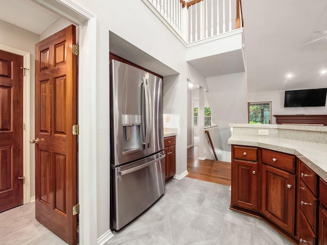 6003 Dunabbey Loop, Dublin, OH 43017 - kitchen with stainless steel refrigerator with ice dispenser, light stone counters, and a ceiling fan