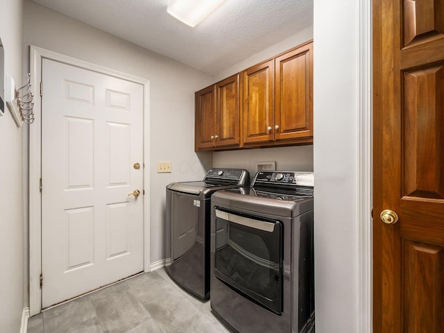 6003 Dunabbey Loop, Dublin, OH 43017 - laundry room with washing machine and dryer, cabinet space, and light tile patterned flooring