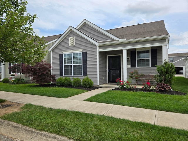 91 Neptune Ave, Newark, OH 43055 - view of front of property featuring a porch, a front lawn, and roof with shingles