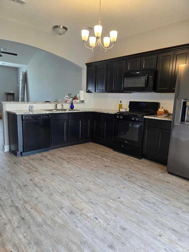 91 Neptune Ave, Newark, OH 43055 - kitchen with black appliances, a chandelier, light wood-style floors, tasteful backsplash, and a peninsula