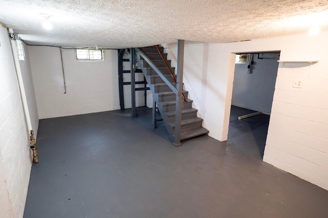 1326 E 19th Ave, Columbus, OH 43211 - basement with concrete block wall, stairs, and a textured ceiling