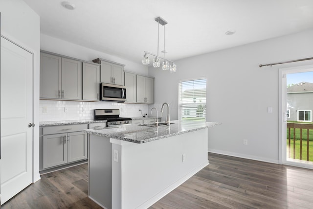 165 Norland Dr, Pickerington, OH 43147 - kitchen with appliances with stainless steel finishes, gray cabinetry, dark wood-style floors, and tasteful backsplash