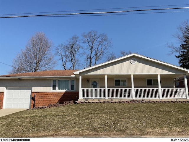 827 Cooper Ave, Bellefontaine, OH 43311 - view of front of property with covered porch, brick siding, a garage, driveway, and a front lawn