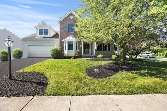 4003 Laurel Valley Dr, Powell, OH 43065 - traditional home featuring driveway, a garage, a front yard, and brick siding