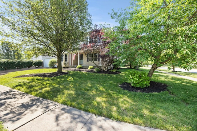 4003 Laurel Valley Dr, Powell, OH 43065 - view of property hidden behind natural elements with a front lawn, a garage, and stucco siding