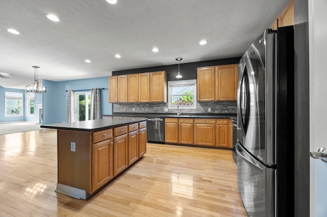 4003 Laurel Valley Dr, Powell, OH 43065 - kitchen featuring stainless steel appliances, dark countertops, light wood finished floors, tasteful backsplash, and recessed lighting