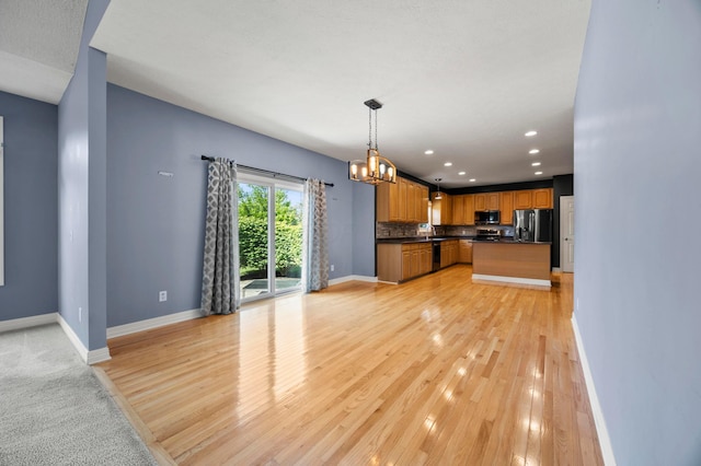 4003 Laurel Valley Dr, Powell, OH 43065 - kitchen with appliances with stainless steel finishes, dark countertops, a chandelier, open floor plan, and recessed lighting