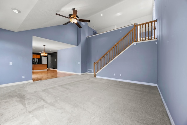 4003 Laurel Valley Dr, Powell, OH 43065 - unfurnished living room featuring ceiling fan, carpet, high vaulted ceiling, and a chandelier