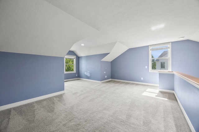 4003 Laurel Valley Dr, Powell, OH 43065 - bonus room with vaulted ceiling, carpet floors, and a textured ceiling