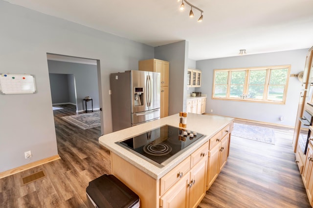 793 Waldo Fulton Rd, Waldo, OH 43356 - kitchen with stainless steel fridge, black electric cooktop, wood finished floors, and light countertops