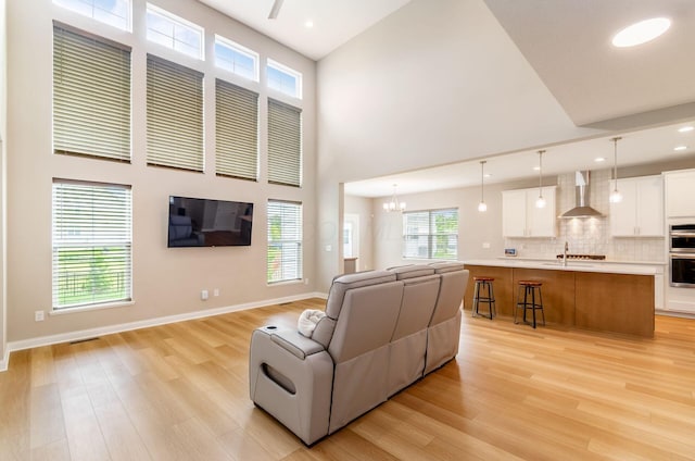 600 Courtright Dr E, Pickerington, OH 43147 - living area with light wood-style flooring, a towering ceiling, a chandelier, and recessed lighting