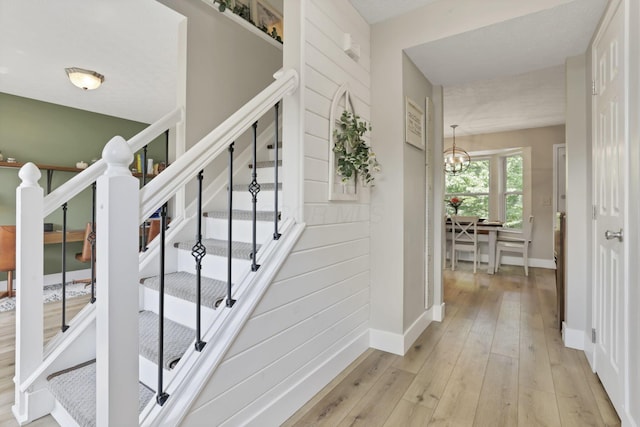 437 Barrington Rdg, Pataskala, OH 43062 - staircase featuring wood-type flooring and a chandelier