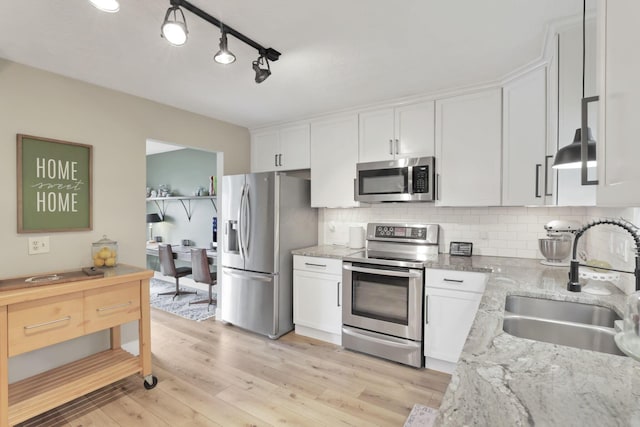 437 Barrington Rdg, Pataskala, OH 43062 - kitchen with appliances with stainless steel finishes, white cabinets, light wood-type flooring, backsplash, and light stone countertops
