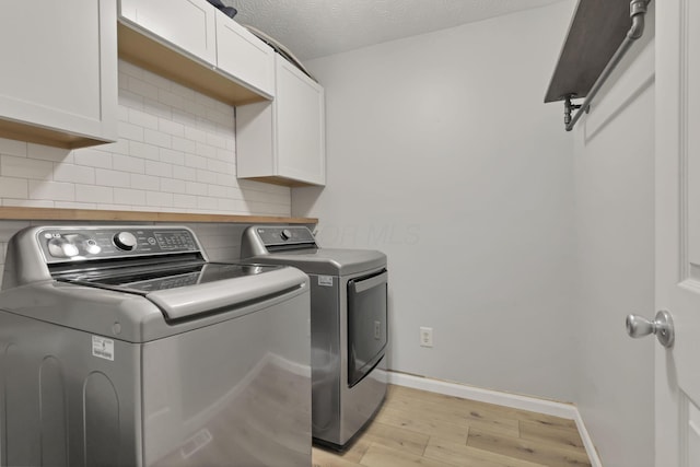 437 Barrington Rdg, Pataskala, OH 43062 - laundry area featuring independent washer and dryer, cabinet space, and light wood finished floors