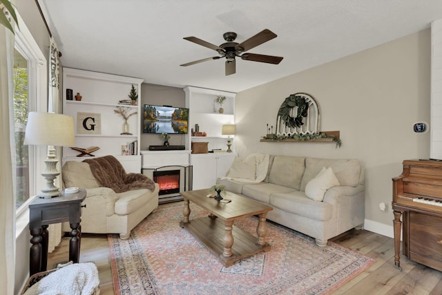 437 Barrington Rdg, Pataskala, OH 43062 - living area with a ceiling fan, wood finished floors, and a glass covered fireplace