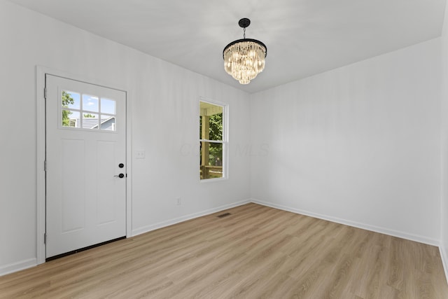 137 E Morrill Ave, Columbus, OH 43207 - foyer featuring a chandelier and light wood-style flooring
