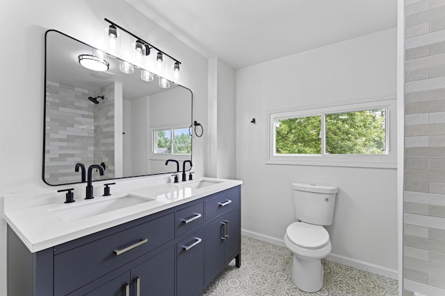 137 E Morrill Ave, Columbus, OH 43207 - bathroom featuring double vanity and a tile shower