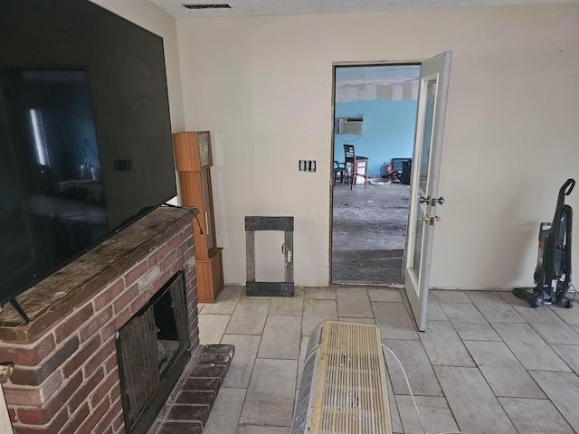 710 Glendower Ave, Columbus, OH 43207 - living room featuring french doors, a brick fireplace, and a wall unit AC