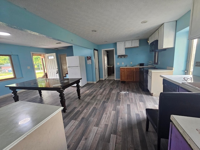 710 Glendower Ave, Columbus, OH 43207 - kitchen with freestanding refrigerator, dark wood finished floors, a textured ceiling, and light countertops