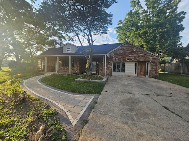 710 Glendower Ave, Columbus, OH 43207 - view of front of home featuring driveway, brick siding, and a porch