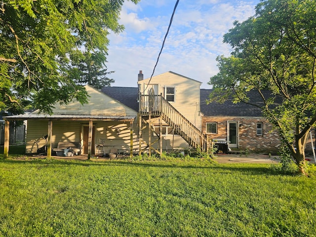 710 Glendower Ave, Columbus, OH 43207 - back of house with a yard, a patio area, a chimney, and stairway