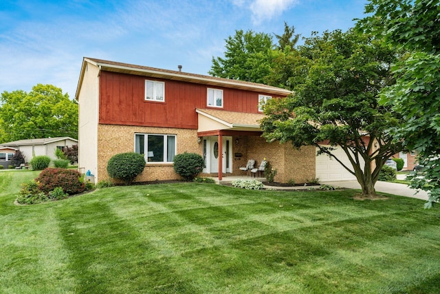 2740 Mitzi Dr, Columbus, OH 43209 - traditional home featuring a front lawn, concrete driveway, a garage, and covered porch