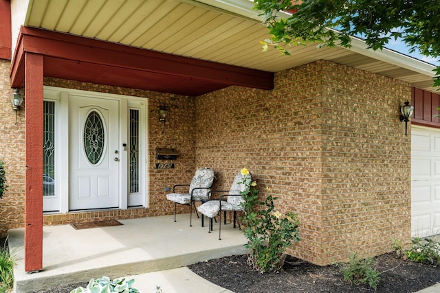 2740 Mitzi Dr, Columbus, OH 43209 - entrance to property featuring brick siding, covered porch, and a garage