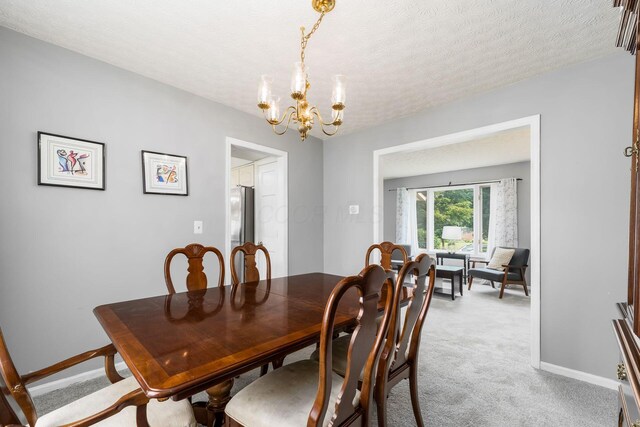 2740 Mitzi Dr, Columbus, OH 43209 - dining area with a chandelier, light carpet, and a textured ceiling