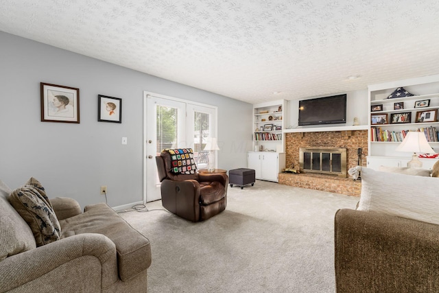 2740 Mitzi Dr, Columbus, OH 43209 - living room with carpet flooring, a fireplace, a textured ceiling, and built in shelves