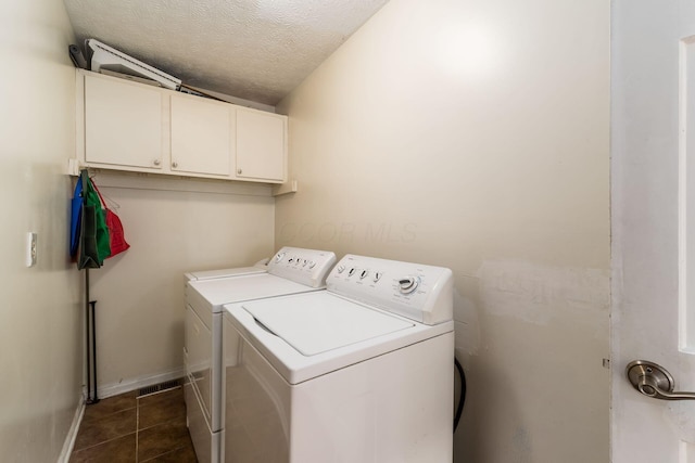 2740 Mitzi Dr, Columbus, OH 43209 - laundry room with independent washer and dryer, cabinet space, a textured ceiling, and dark tile patterned flooring