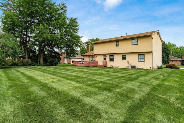 2740 Mitzi Dr, Columbus, OH 43209 - back of property with a wooden deck, a lawn, and stucco siding