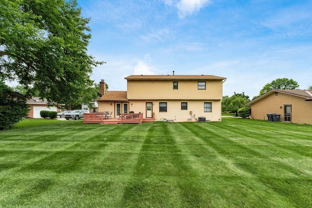 2740 Mitzi Dr, Columbus, OH 43209 - rear view of house featuring stucco siding, a deck, a chimney, and a yard