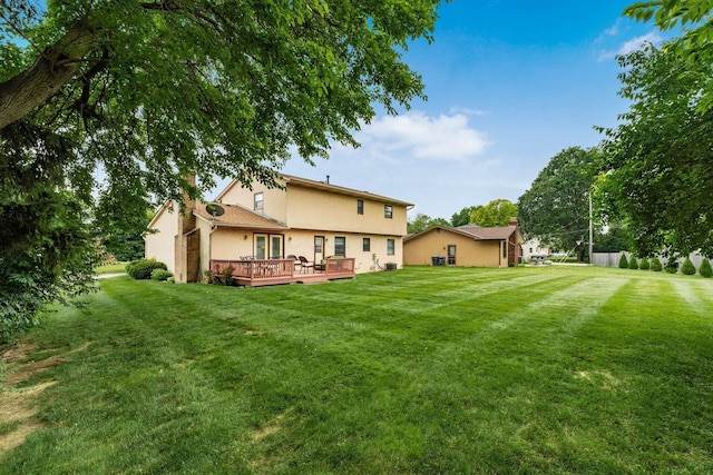 2740 Mitzi Dr, Columbus, OH 43209 - back of house featuring stucco siding, a wooden deck, a lawn, and a chimney