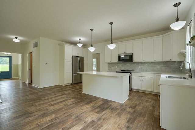 3663 Cedar Hill Rd NW, Canal Winchester, OH 43110 - kitchen with stainless steel appliances, dark wood-type flooring, decorative backsplash, a kitchen island, and white cabinetry