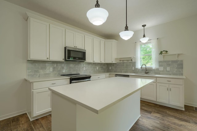 3663 Cedar Hill Rd NW, Canal Winchester, OH 43110 - kitchen featuring appliances with stainless steel finishes, dark wood-style flooring, light countertops, and decorative backsplash