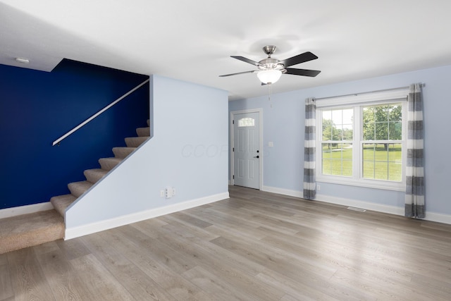6704 Blacks Rd SW, Pataskala, OH 43062 - unfurnished living room with stairs, wood finished floors, and ceiling fan