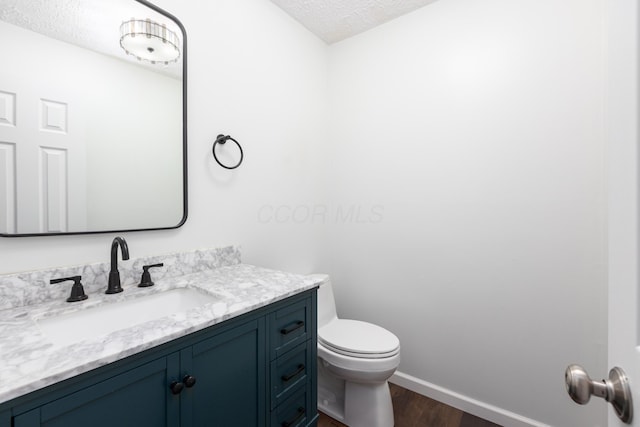 6704 Blacks Rd SW, Pataskala, OH 43062 - half bathroom featuring wood finished floors, a textured ceiling, and vanity