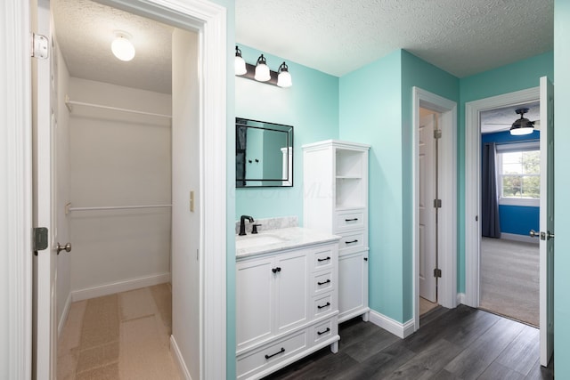 6704 Blacks Rd SW, Pataskala, OH 43062 - bathroom with a textured ceiling, vanity, and wood finished floors