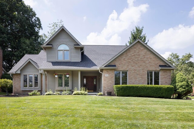 833 Moon Glow Ct, Columbus, OH 43230 - view of front of home featuring a front lawn, roof with shingles, and brick siding