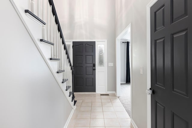 833 Moon Glow Ct, Columbus, OH 43230 - foyer with light tile patterned flooring, a high ceiling, and stairway
